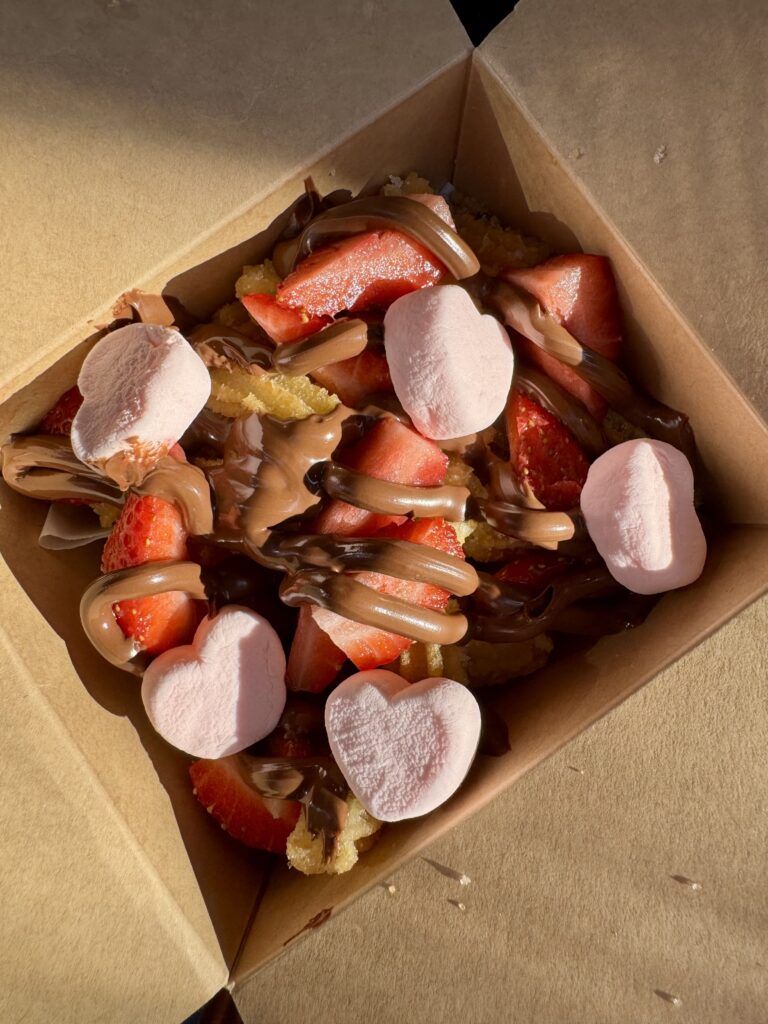 A box filled with strawberry pieces and candy.