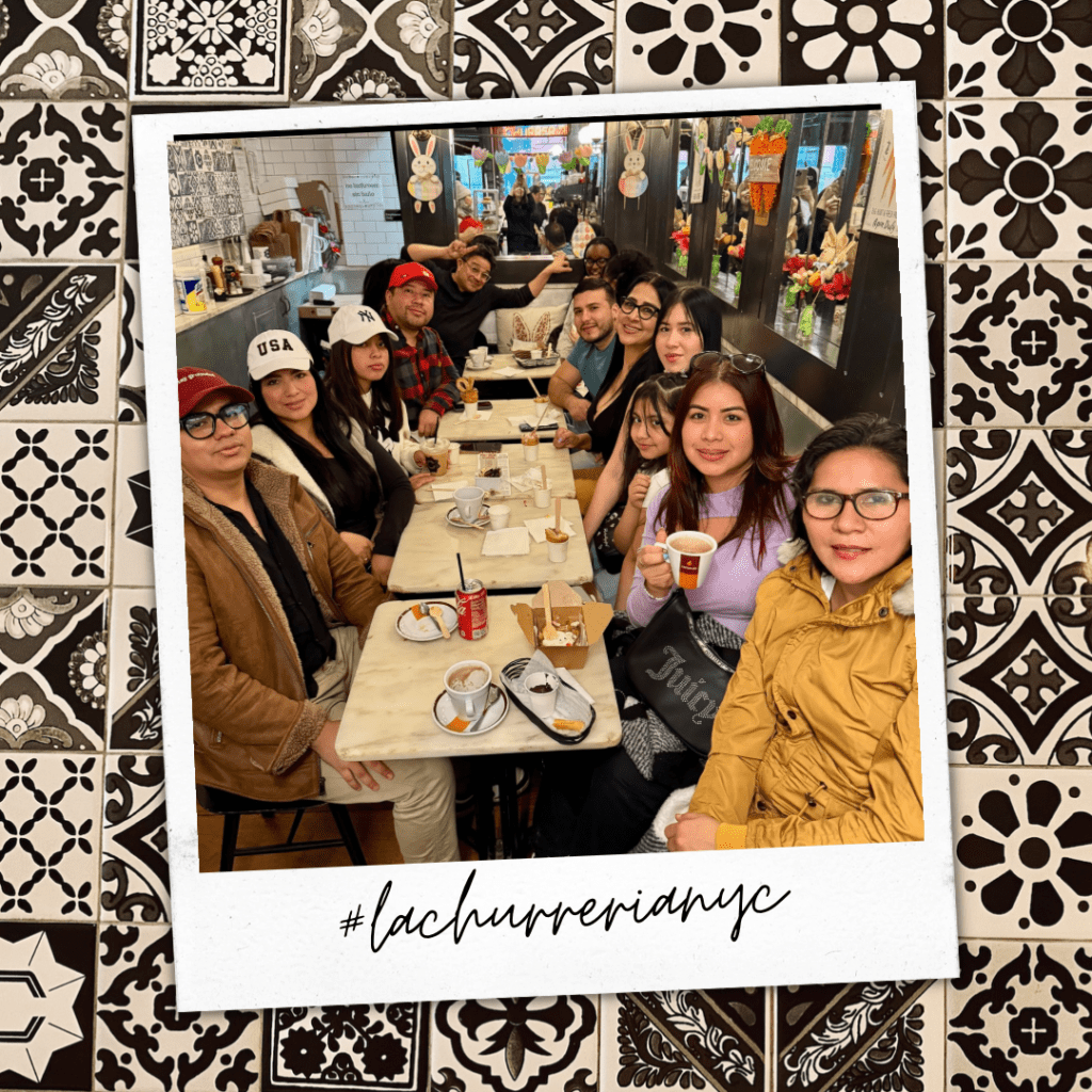 Friends laughing and sharing churros and hot chocolate at La Churrería NYC.